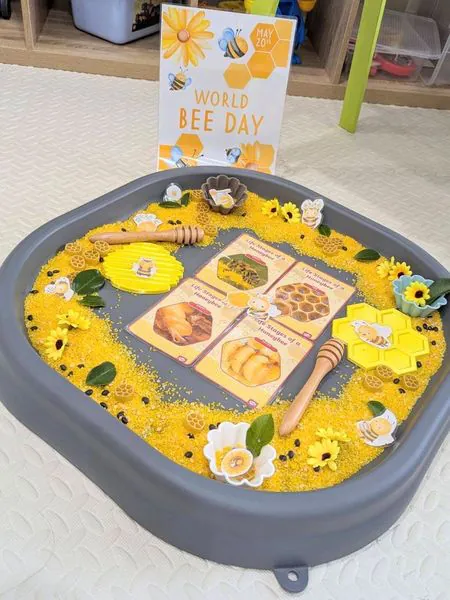 A World Bee Day sensory tray with honeycomb and bees