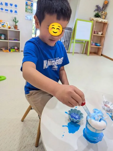 A child using a dropper in a colour-mixing experiment